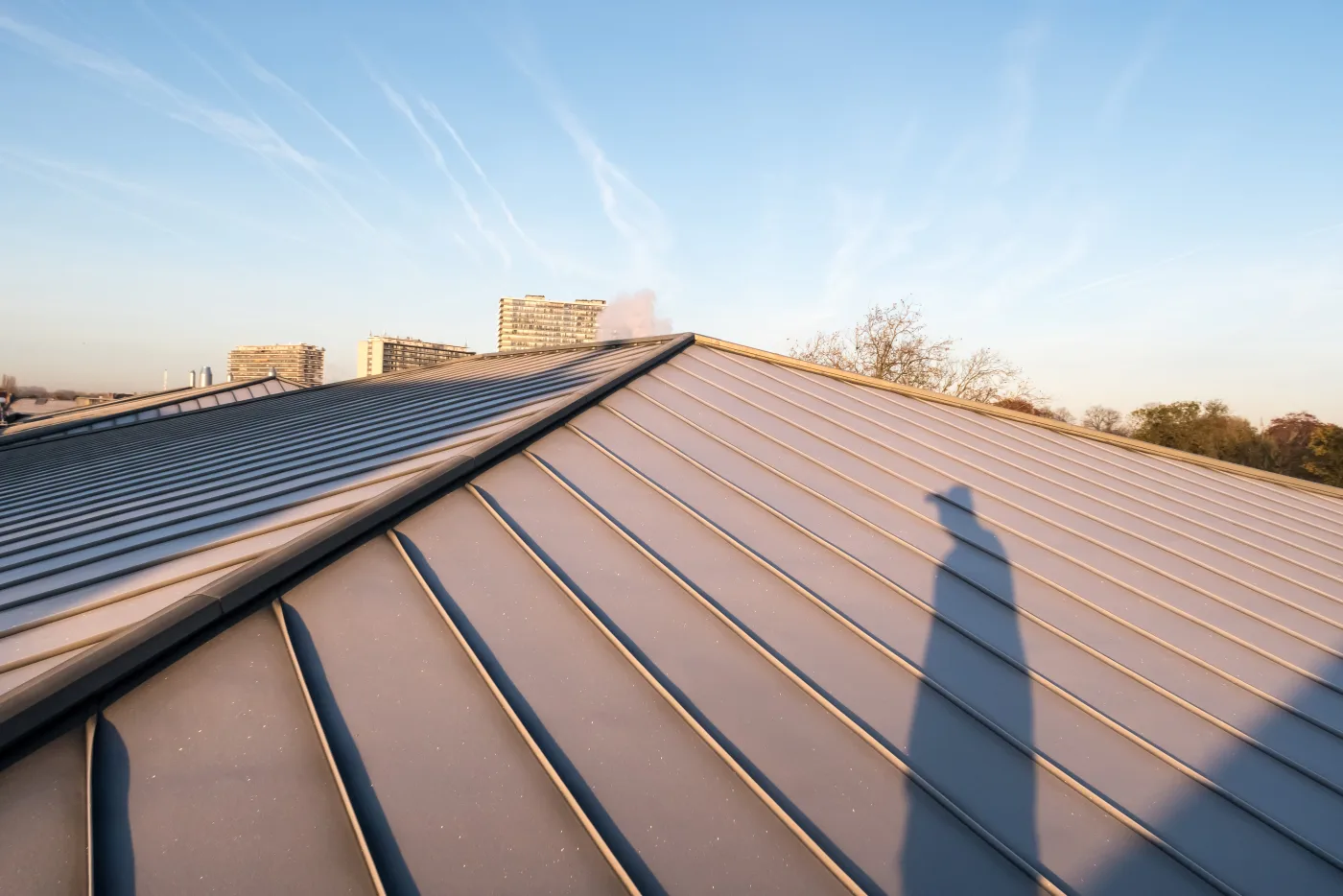 Standing seam metal roof panels meeting at the ridge