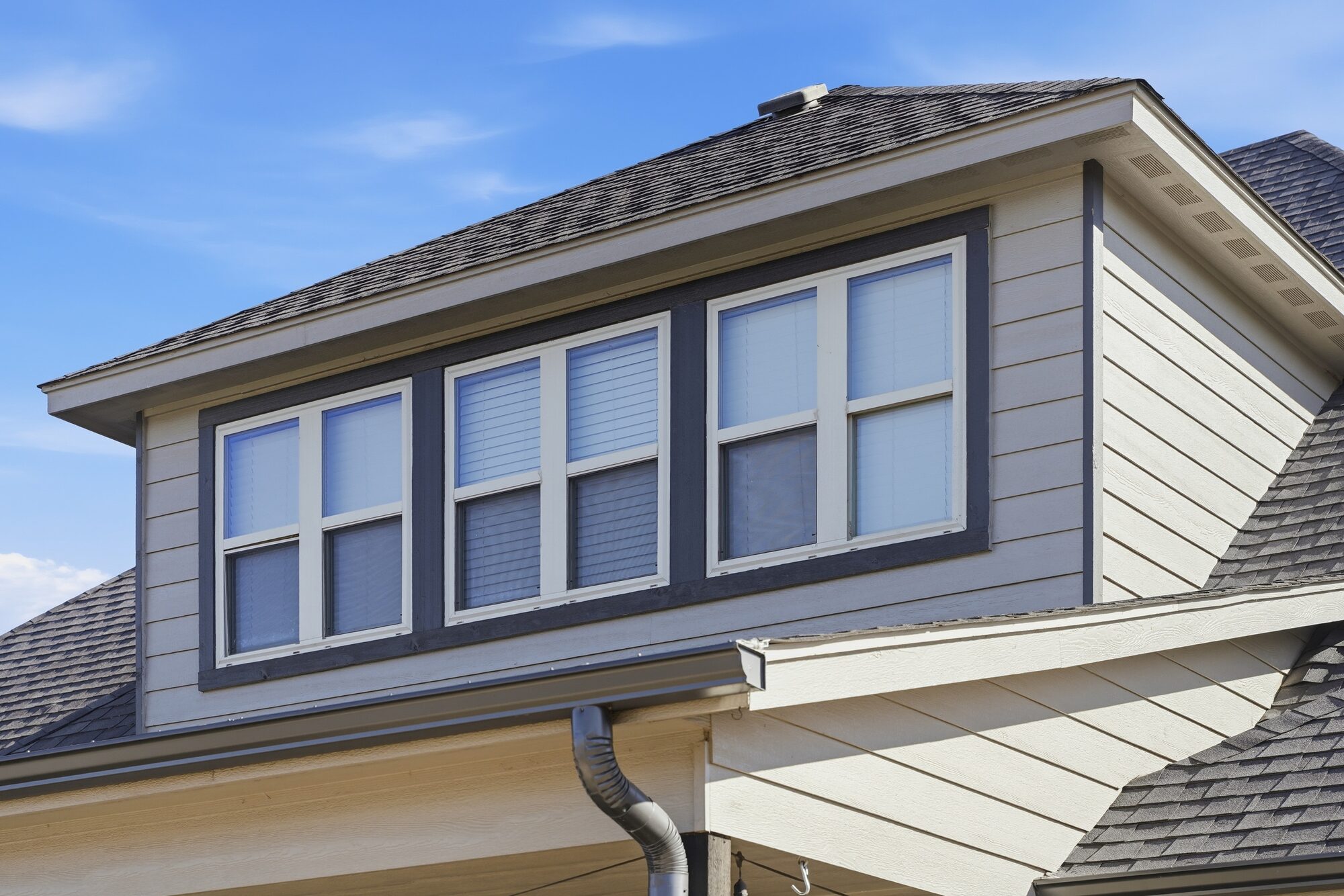 Close-up of a home roofline and dormer after storm repair