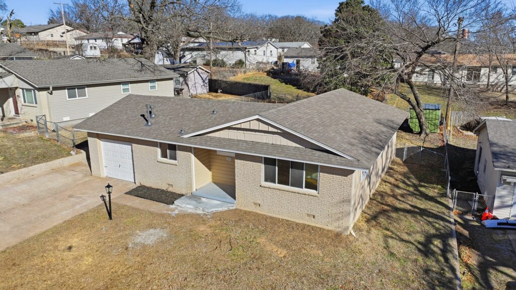 Aerial drone view of a home with a completed roof