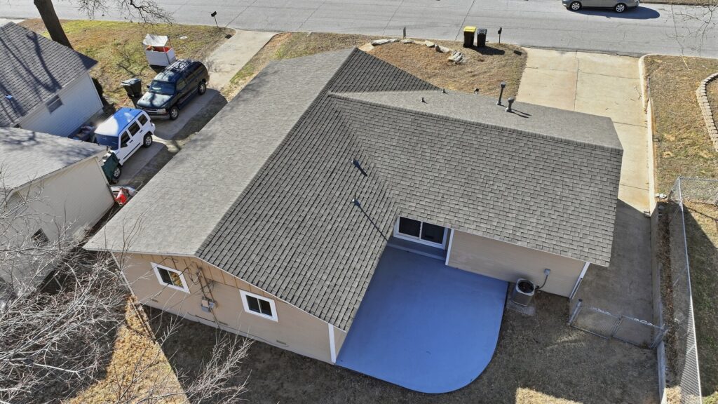 Aerial view of a completed shingle roof on a Tulsa area ranch home