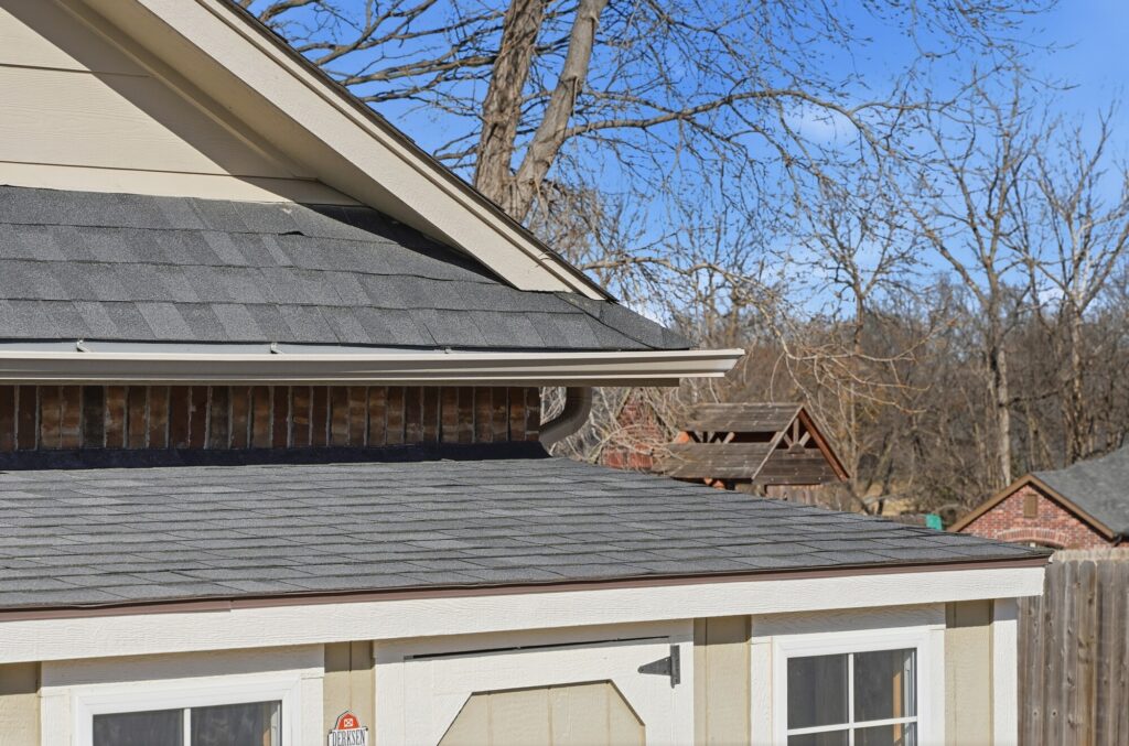 Roof edge with a seamless gutter and downspout on a completed roof