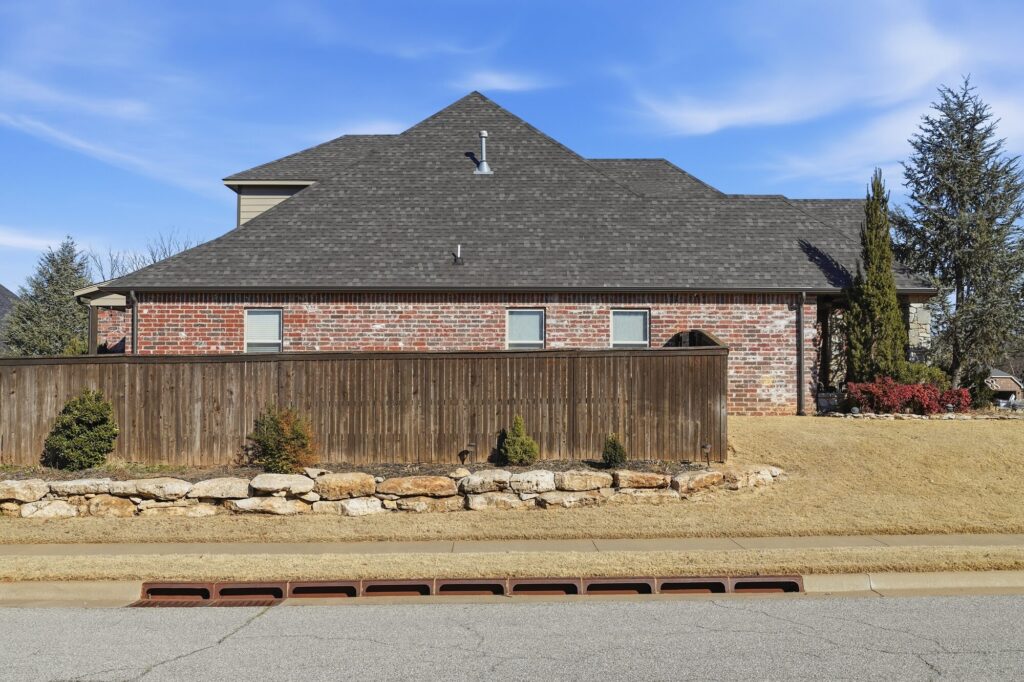 Brick home exterior with a newly installed shingle roof